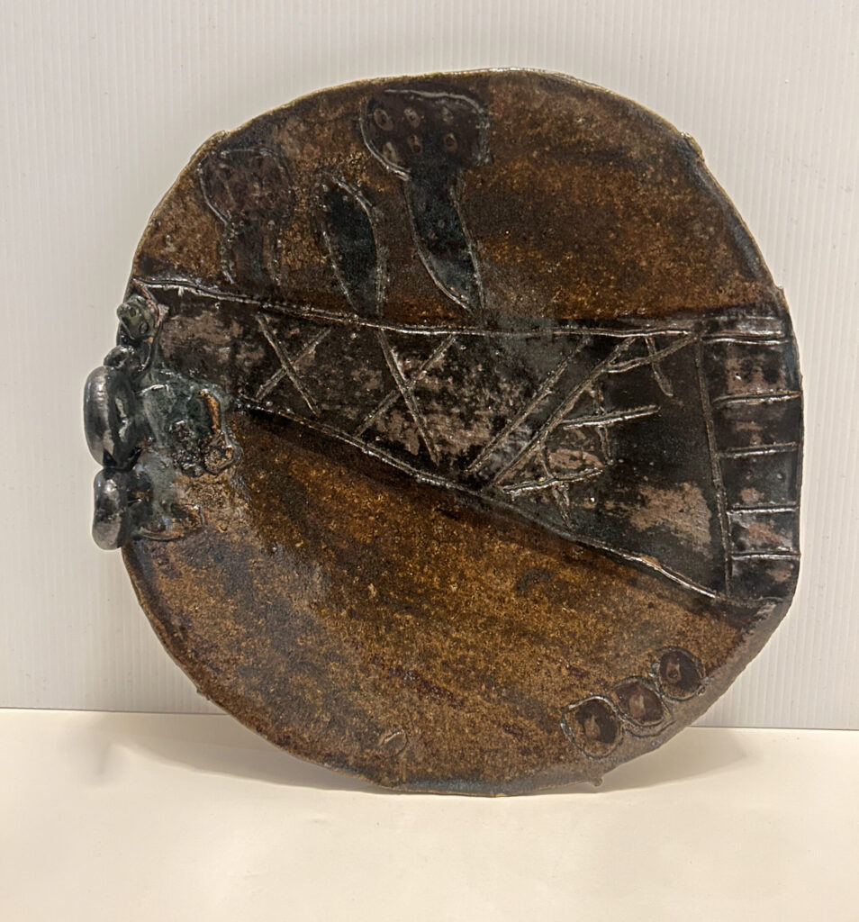 Untitled (Plate with brown and black glaze, incising & attachments)